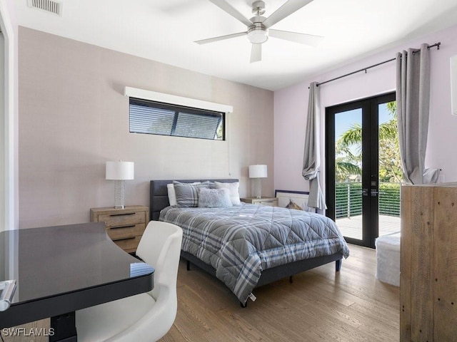 bedroom featuring visible vents, ceiling fan, french doors, wood finished floors, and access to outside