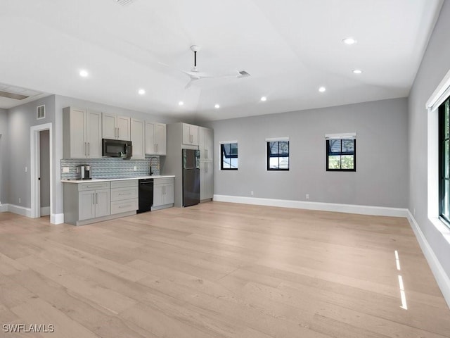 kitchen featuring visible vents, recessed lighting, gray cabinets, black appliances, and tasteful backsplash