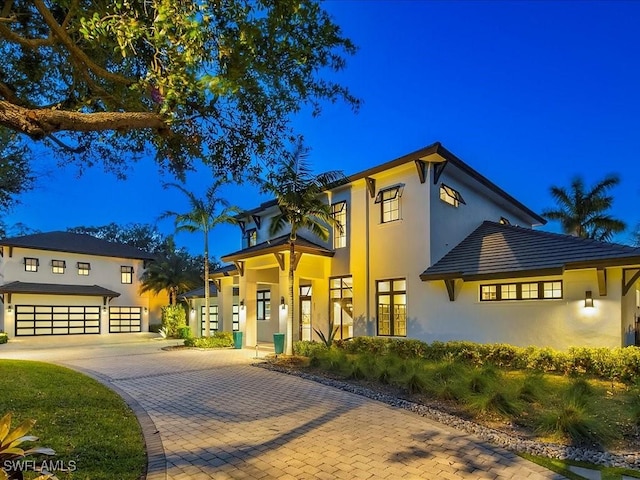 view of front of house featuring stucco siding and a garage