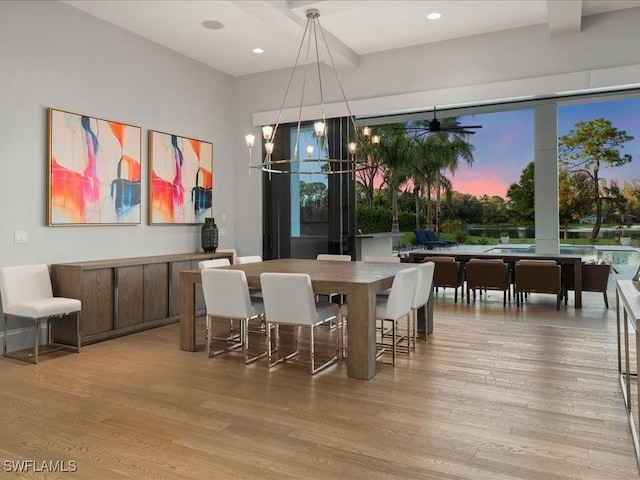 dining area with beamed ceiling, a notable chandelier, wood finished floors, and recessed lighting