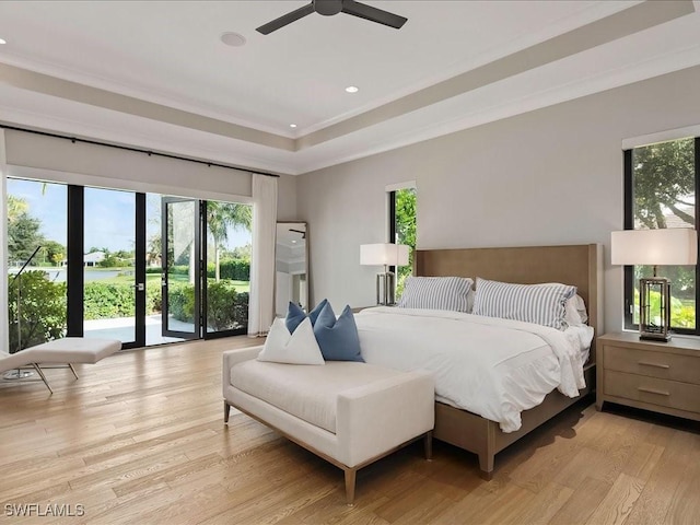 bedroom featuring crown molding, recessed lighting, light wood-style flooring, a raised ceiling, and a ceiling fan