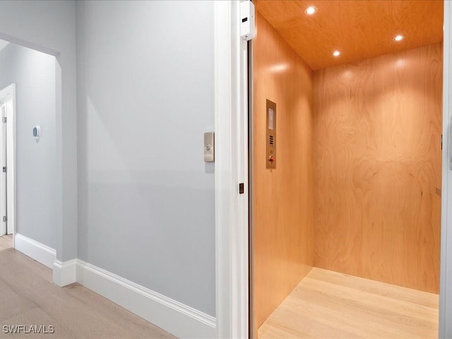 interior space with elevator, recessed lighting, and baseboards