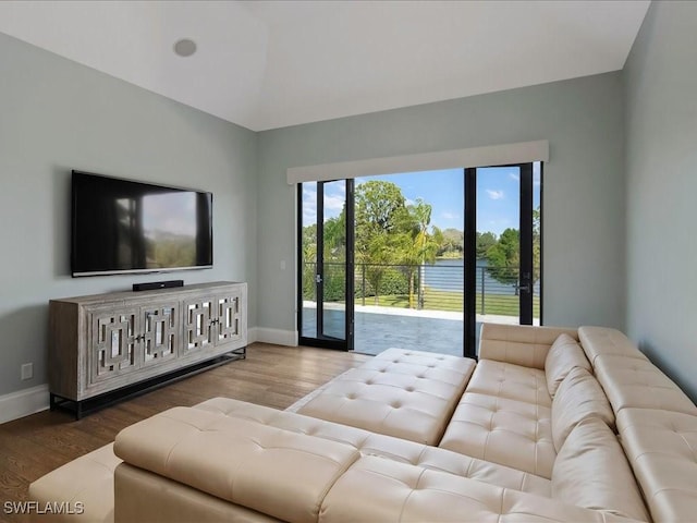 living area featuring baseboards and wood finished floors