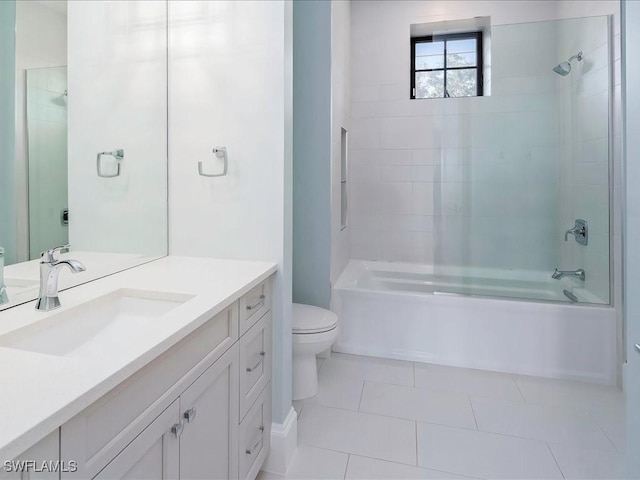 full bathroom featuring vanity, toilet,  shower combination, and tile patterned flooring