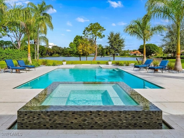 view of pool with a water view, a pool with connected hot tub, and a patio area