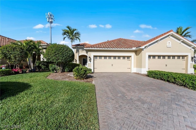 mediterranean / spanish-style home featuring stucco siding, a front lawn, a garage, a tile roof, and decorative driveway