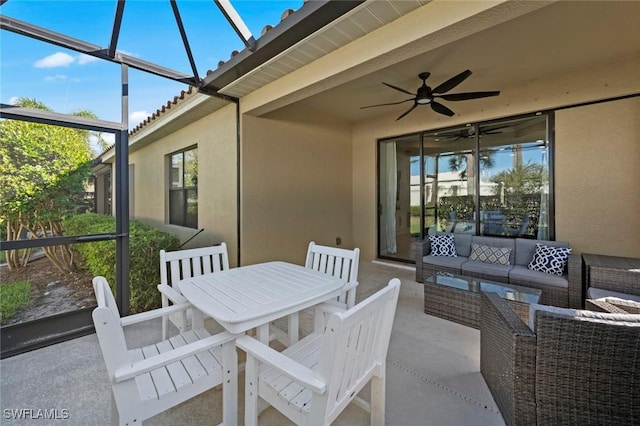 view of patio / terrace featuring a lanai, outdoor dining area, ceiling fan, and outdoor lounge area