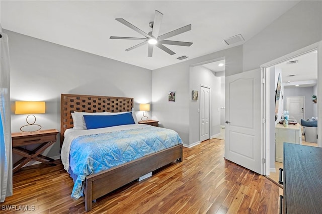 bedroom featuring visible vents, baseboards, ceiling fan, light wood-style floors, and a closet