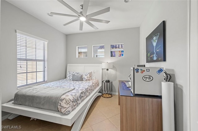 bedroom with light tile patterned floors, baseboards, and ceiling fan