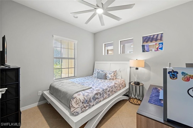 tiled bedroom featuring ceiling fan and baseboards