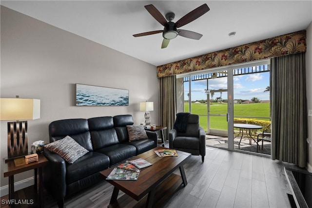 living room featuring ceiling fan, baseboards, and wood finished floors