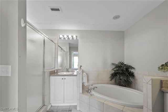 bathroom featuring a garden tub, vanity, visible vents, and a shower stall