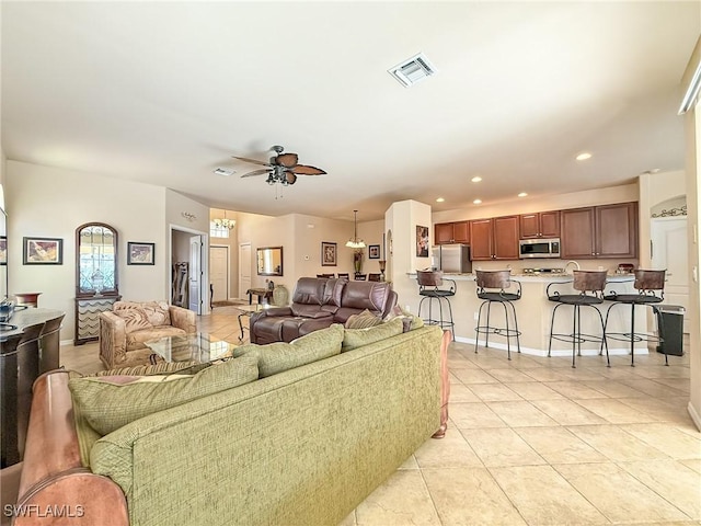 living area with light tile patterned floors, baseboards, visible vents, recessed lighting, and ceiling fan