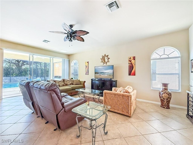 living room featuring light tile patterned floors, a ceiling fan, and visible vents