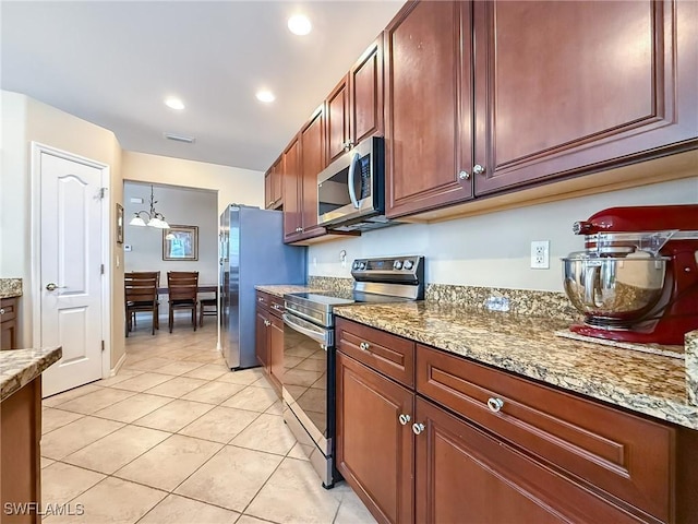 kitchen featuring light stone counters, light tile patterned flooring, recessed lighting, and appliances with stainless steel finishes