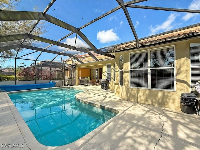 pool with a lanai and a patio area