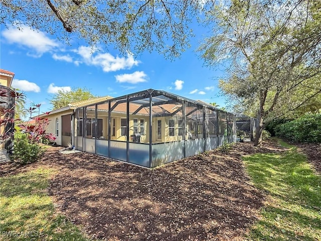 rear view of property with a lanai