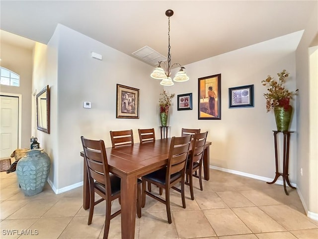 dining space with light tile patterned floors, a notable chandelier, and baseboards