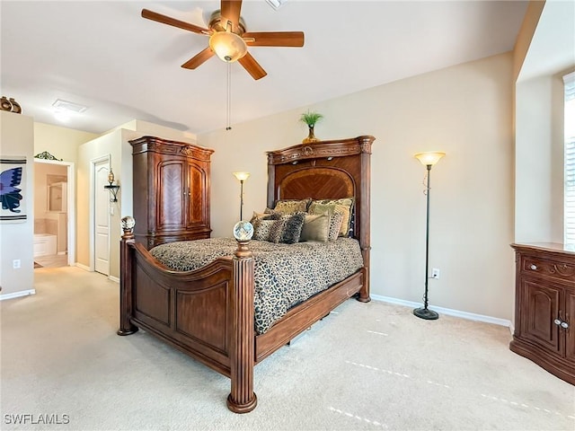 bedroom with light colored carpet, baseboards, and connected bathroom