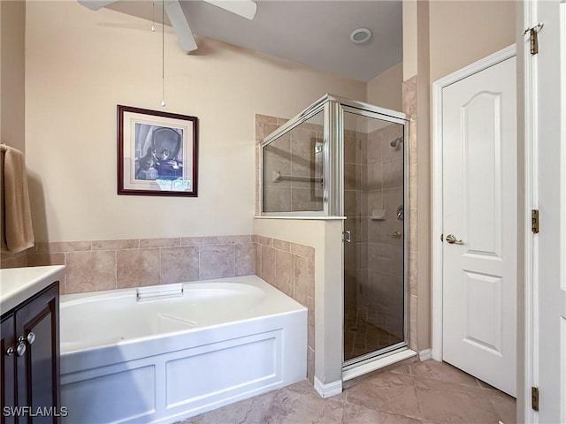 bathroom with a garden tub, a stall shower, and vanity