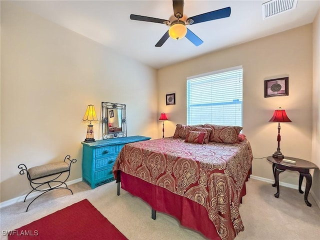 bedroom featuring visible vents, a ceiling fan, baseboards, and carpet floors