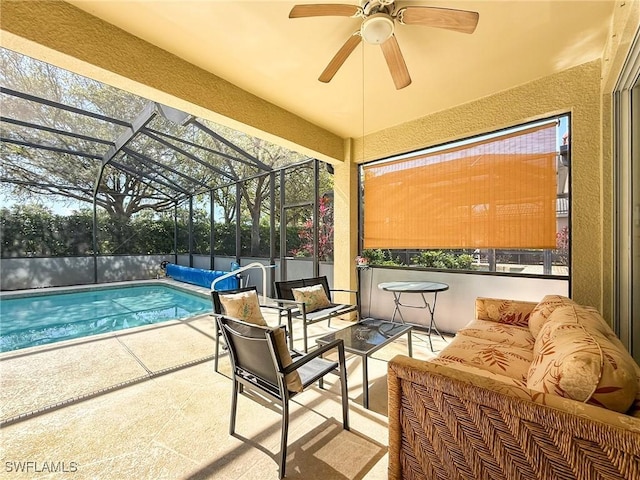 exterior space with an outdoor living space, glass enclosure, ceiling fan, and a fenced in pool