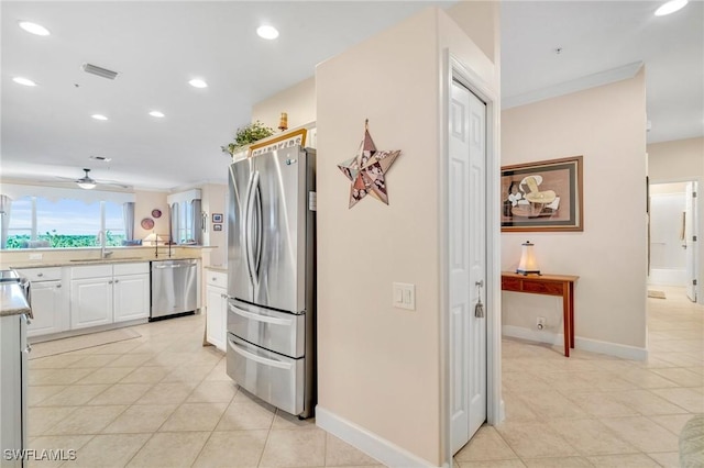 kitchen featuring visible vents, a sink, light countertops, appliances with stainless steel finishes, and white cabinetry