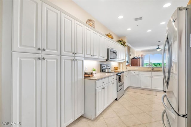 kitchen with stainless steel appliances, visible vents, white cabinets, and light countertops