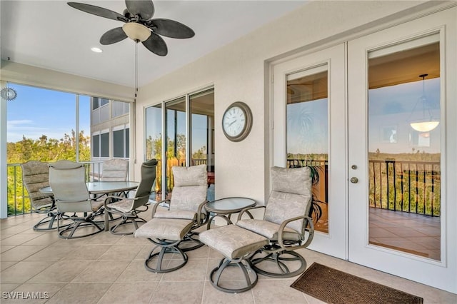 sunroom / solarium featuring french doors and ceiling fan