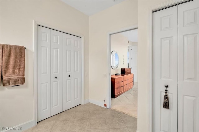 bedroom featuring light tile patterned flooring and baseboards