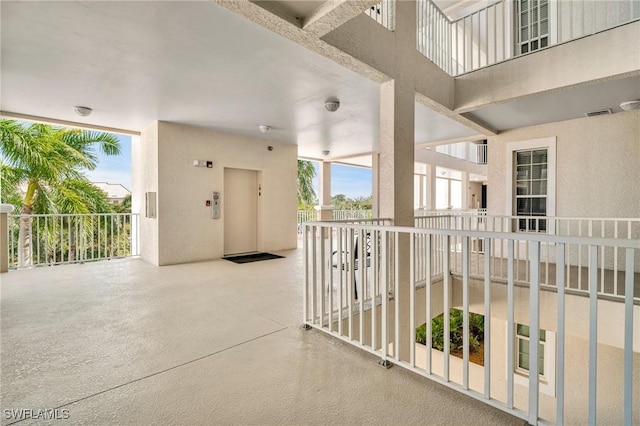 interior space featuring elevator and a balcony