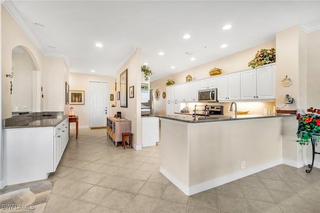 kitchen featuring a peninsula, white cabinets, recessed lighting, and appliances with stainless steel finishes