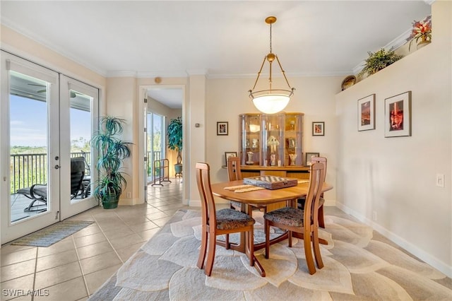 dining room featuring light tile patterned floors, french doors, crown molding, and baseboards