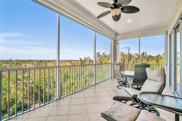 unfurnished sunroom with a wealth of natural light and a ceiling fan