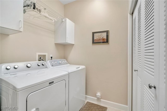 washroom with tile patterned floors, cabinet space, baseboards, and washing machine and clothes dryer