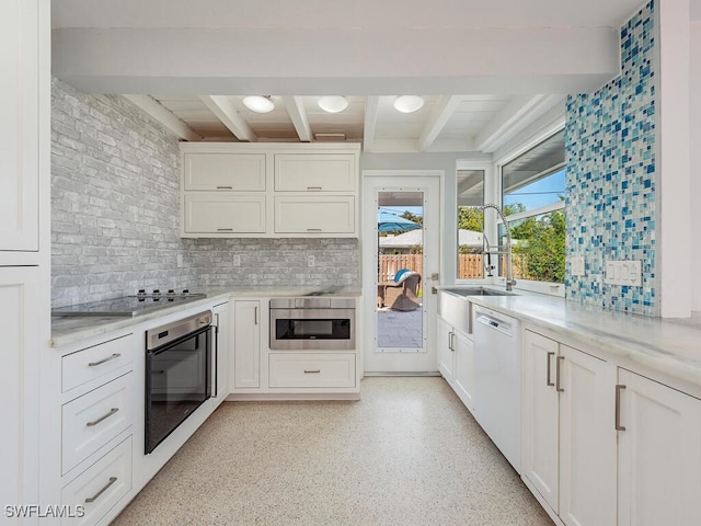 kitchen with beam ceiling, black electric cooktop, dishwasher, wall oven, and oven