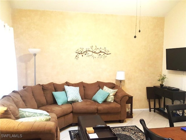 living room with tile patterned flooring and baseboards