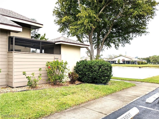 view of home's exterior featuring a lawn and stucco siding