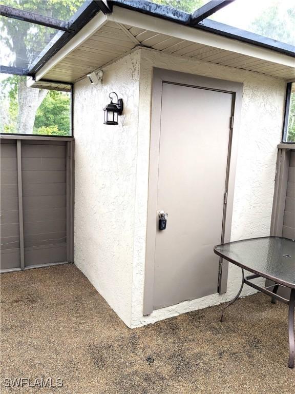 entrance to property featuring stucco siding