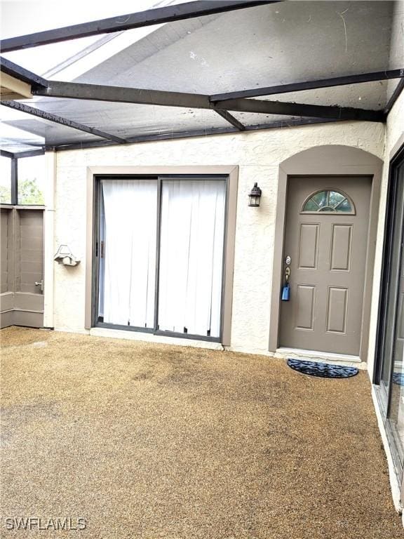 view of exterior entry with stucco siding