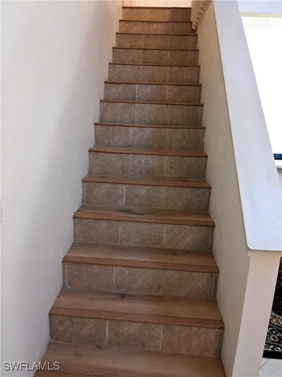 stairs featuring wood finished floors