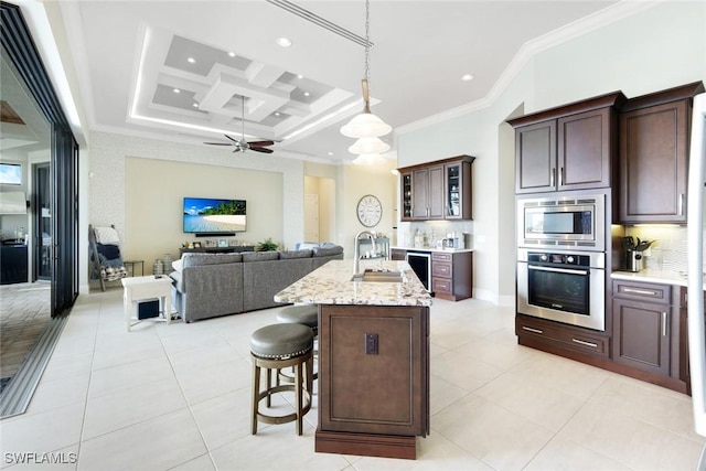 kitchen featuring ornamental molding, light tile patterned flooring, coffered ceiling, stainless steel appliances, and a sink