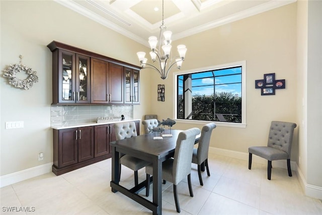 dining area featuring light tile patterned floors, baseboards, coffered ceiling, ornamental molding, and a chandelier