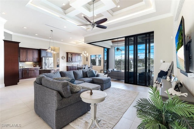 living room with ornamental molding, light tile patterned floors, ceiling fan with notable chandelier, a high ceiling, and coffered ceiling