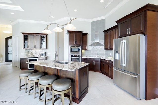 kitchen featuring beverage cooler, a sink, appliances with stainless steel finishes, crown molding, and wall chimney range hood