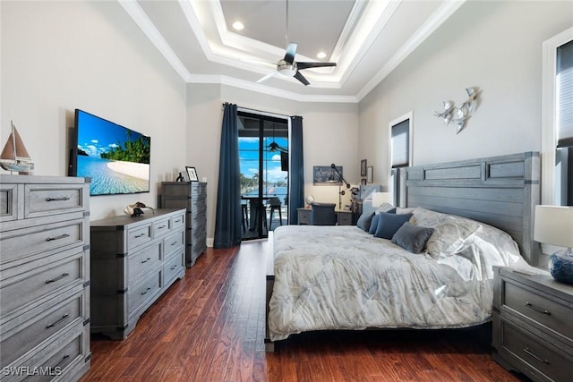 bedroom with a raised ceiling, dark wood-type flooring, crown molding, and access to outside