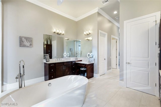 full bath featuring tile patterned floors, visible vents, crown molding, a freestanding bath, and vanity