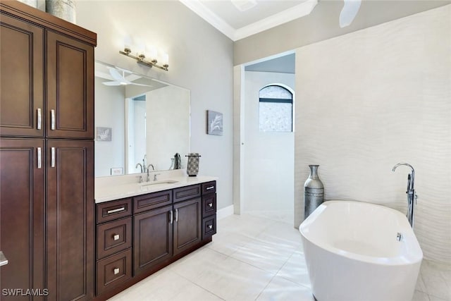 bathroom with vanity, a soaking tub, crown molding, and tile patterned flooring