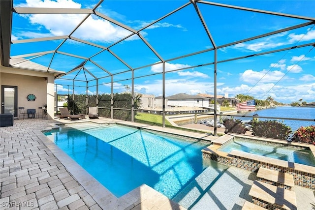 view of pool with a patio, a water view, a pool with connected hot tub, and a lanai