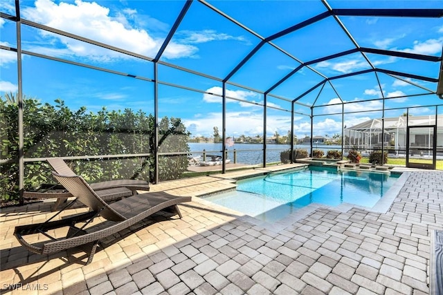 view of pool featuring glass enclosure, a water view, and a patio area